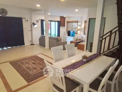 Spacious open-plan living and dining area with modern decor and ample natural light.