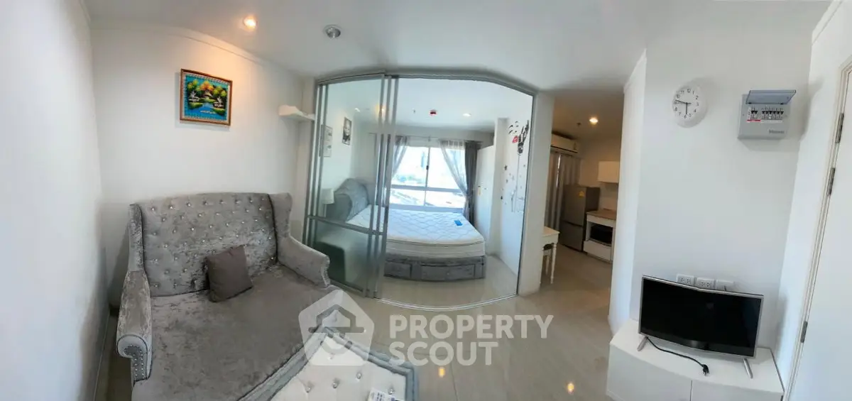 Modern studio apartment with elegant decor and open layout, featuring a cozy living area and stylish kitchen.