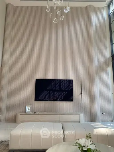 Luxurious modern living room with high ceilings and elegant decor