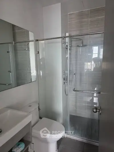 Modern bathroom with glass shower enclosure and sleek fixtures