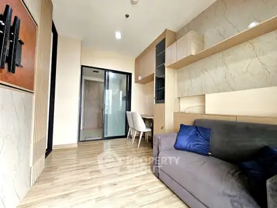 Modern living room with sleek design and wooden flooring, featuring a cozy sofa and stylish shelving.