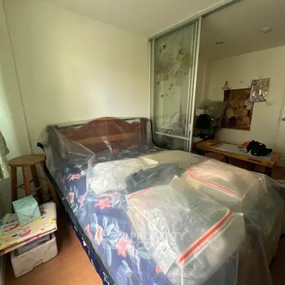 Cozy bedroom with wooden bed and sliding closet doors, perfect for a restful retreat.