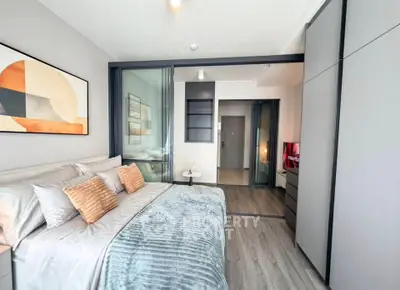 Modern bedroom with stylish decor and sliding glass doors in a contemporary apartment.