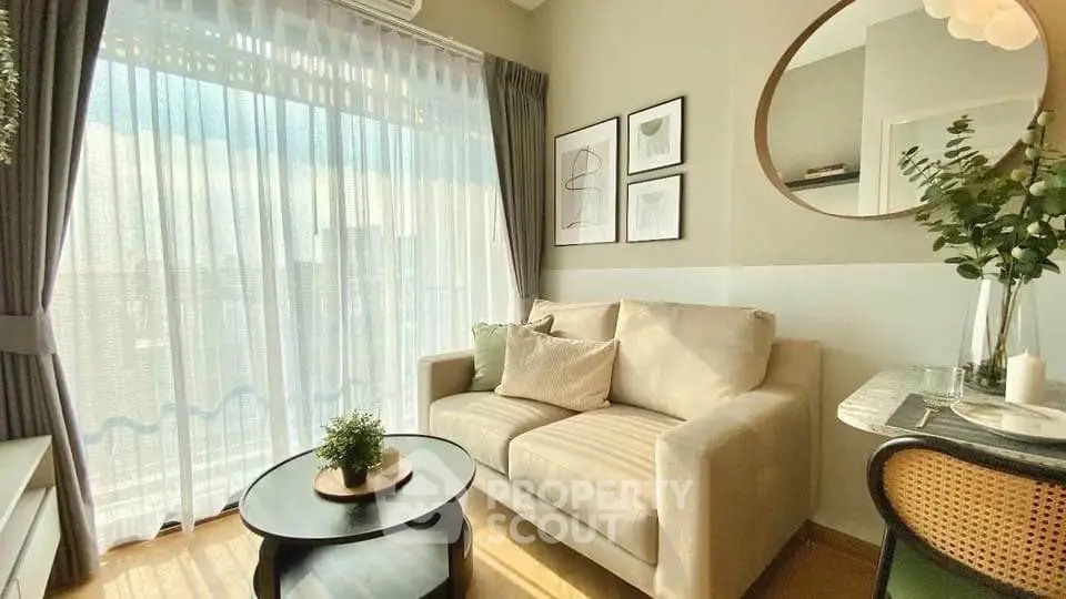 Bright and cozy living room with modern decor and large window view.