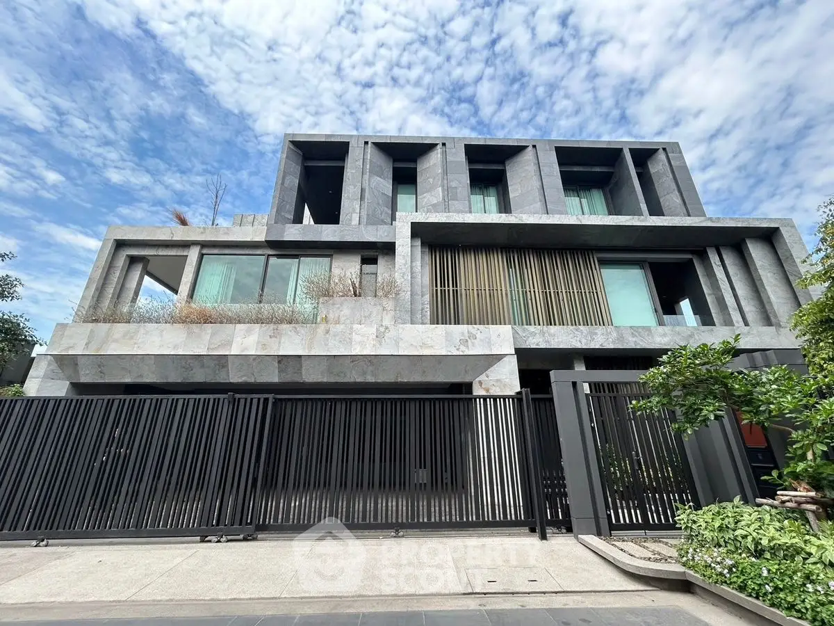Modern luxury building with sleek design and large windows under a clear blue sky.