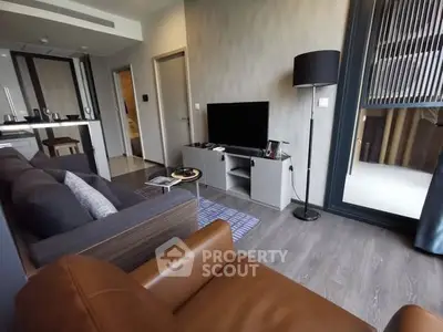 Modern living room with sleek furniture and open kitchen layout