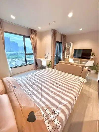 Modern bedroom with large window and city view, featuring cozy bed and stylish decor.