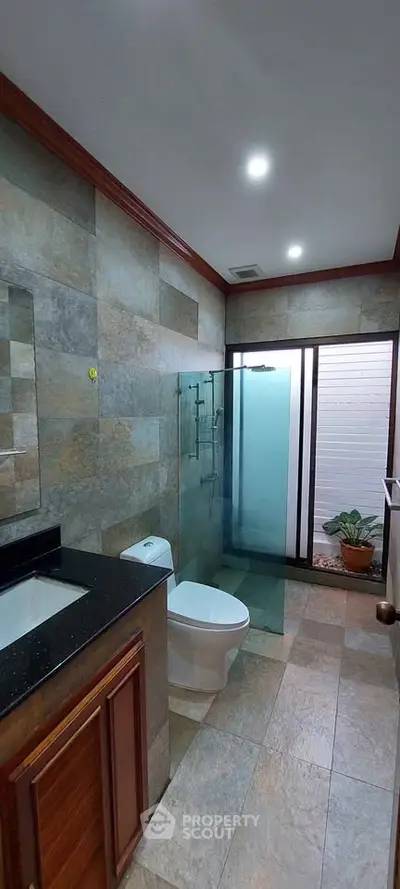 Elegant bathroom with modern fixtures and glass shower enclosure
