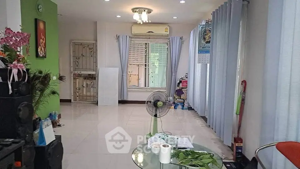 Spacious living room with modern decor and large windows for natural light.