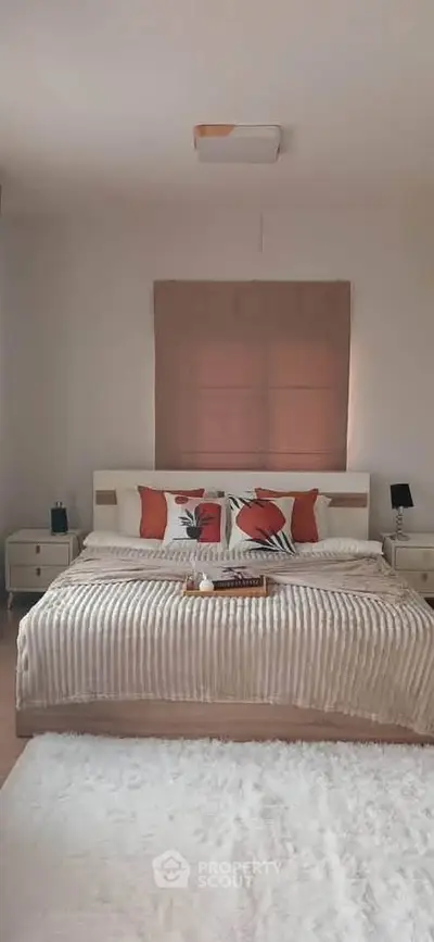 Cozy bedroom with stylish decor and plush bedding