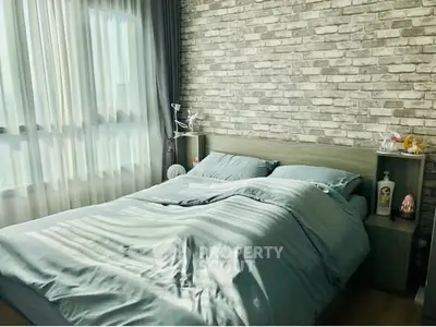 Cozy bedroom with brick accent wall and soft natural lighting