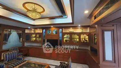 Luxurious living room with elegant wooden cabinetry and chandelier lighting