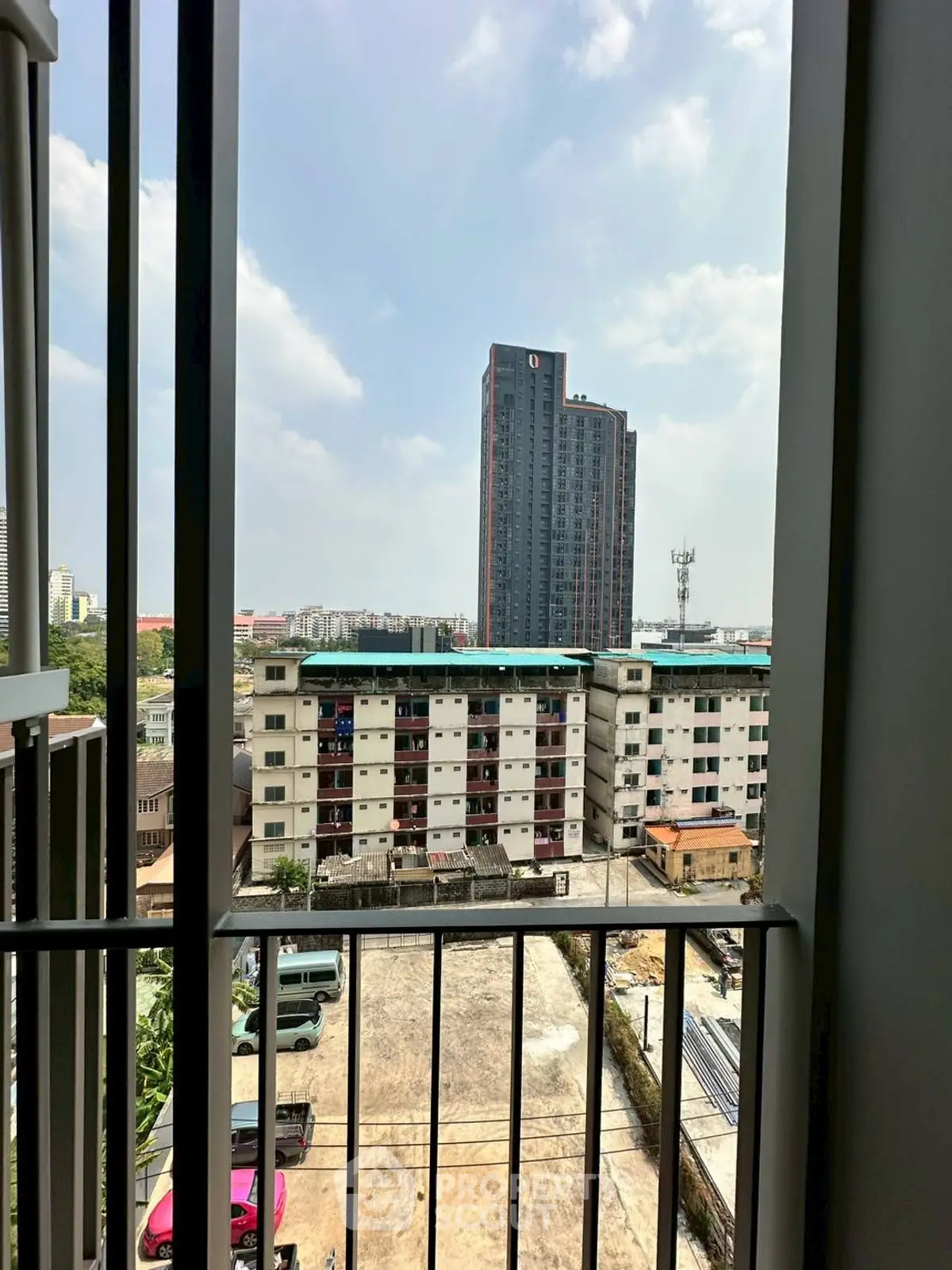 Urban apartment view with high-rise building and parking area