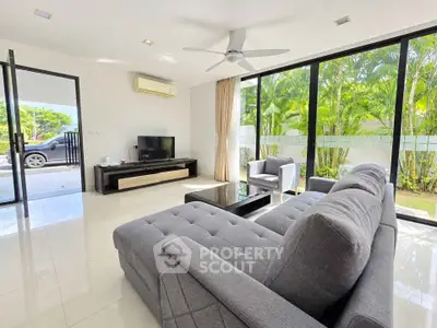 Spacious modern living room with large windows and garden view