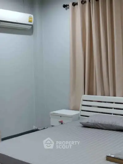 Cozy bedroom with modern air conditioning and stylish curtains