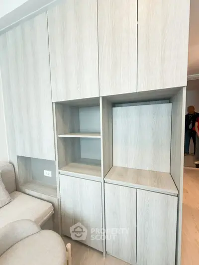 Modern built-in storage cabinets in a stylish living room with light wood finish.