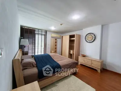 Spacious bedroom with modern wooden furniture and cozy decor