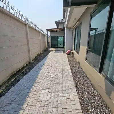Spacious modern home exterior with paved driveway and sleek design.
