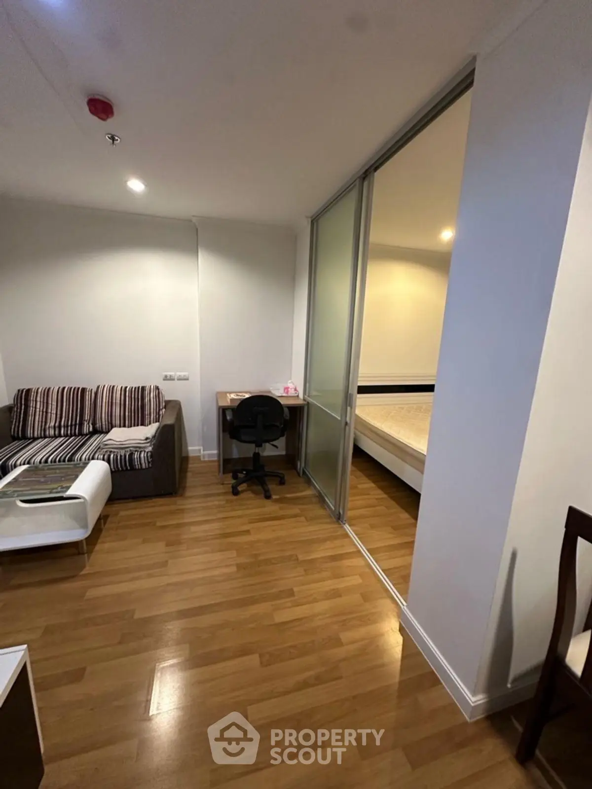 Modern apartment with cozy living area and sliding bedroom partition