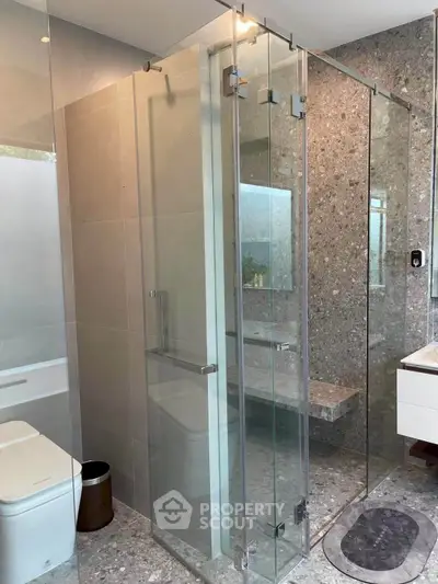 Modern bathroom with glass shower enclosure and sleek design