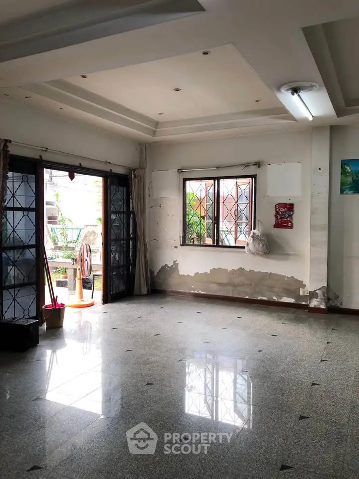 Spacious living room with large windows and natural light, ideal for customization.