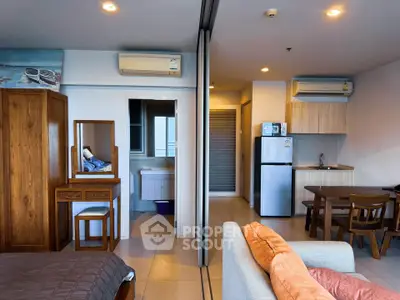 Modern studio apartment with open layout, featuring cozy living area, compact kitchen, and stylish furnishings.