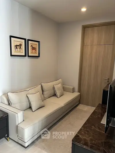 Cozy living room with elegant sofa and stylish decor in modern apartment.