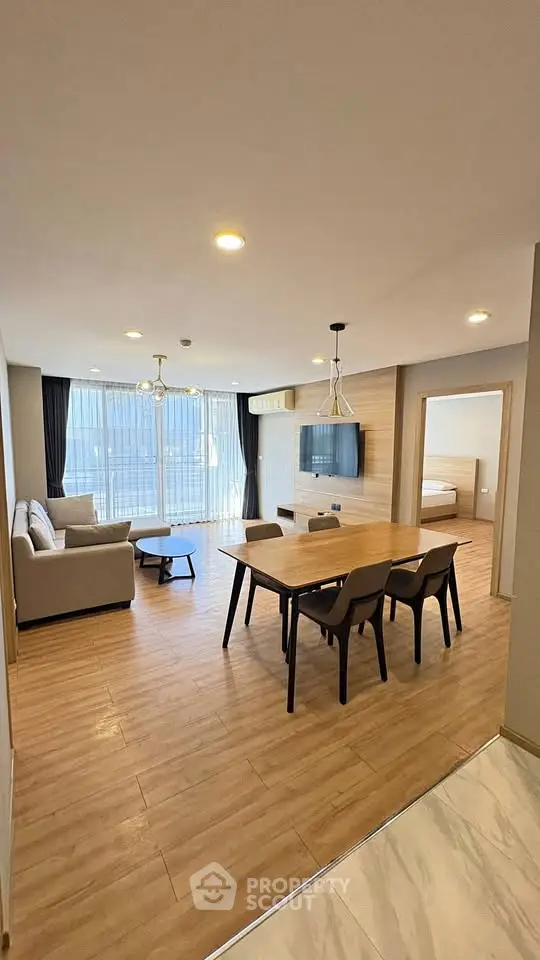 Spacious modern living room with open layout and elegant wooden flooring