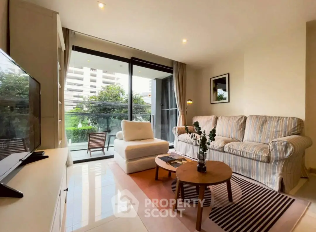 Spacious living room with modern decor and balcony view