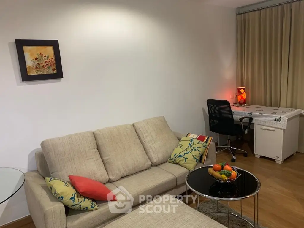 Cozy living room with modern decor and a small study area, perfect for relaxation and productivity.