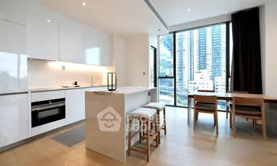 Modern open kitchen with sleek design and city view, featuring island and dining area.