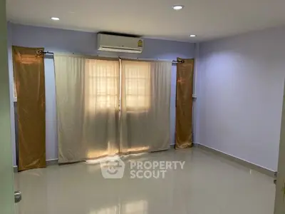 Spacious empty room with air conditioning and large windows