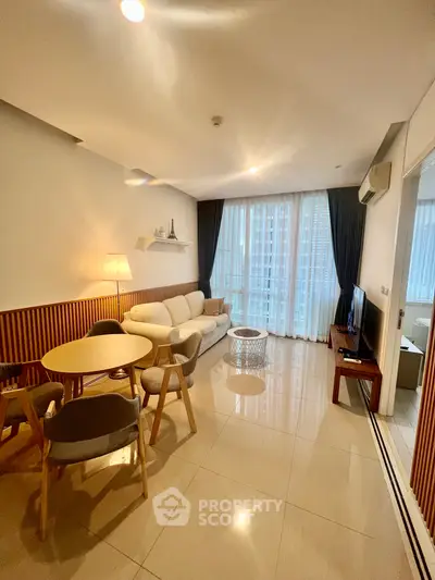 Modern living room with stylish furniture and large windows offering natural light.