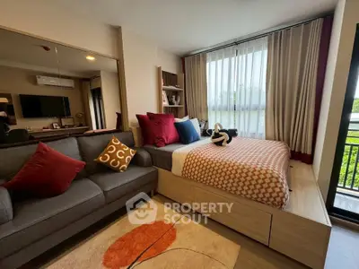 Modern bedroom with stylish decor and large window offering natural light