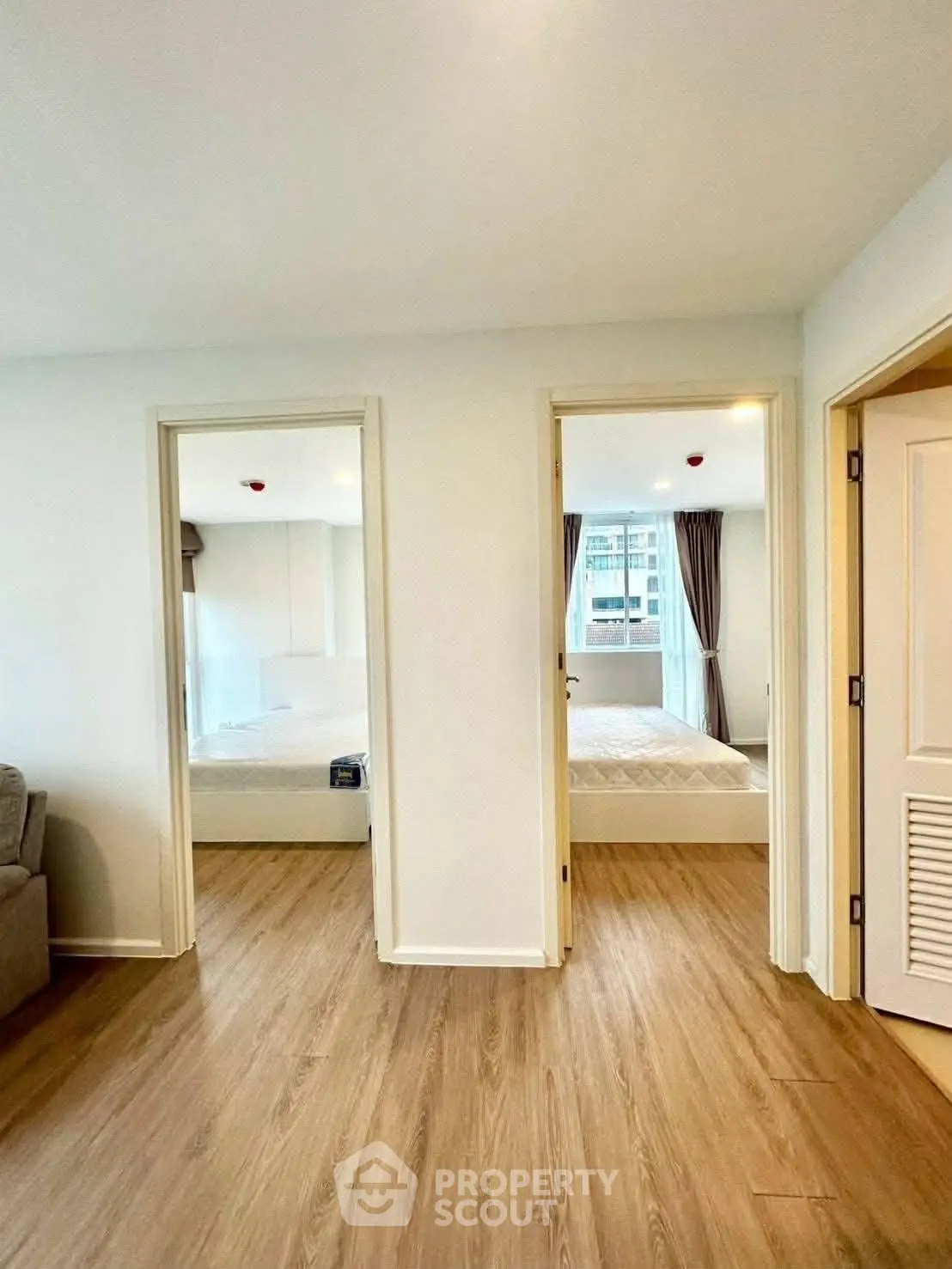 Spacious apartment interior with wooden flooring and bright natural light