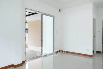 Spacious interior with sliding glass door leading to outdoor area, perfect for natural light.