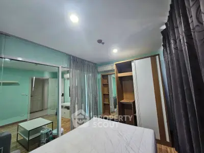 Spacious bedroom with modern furnishings and ample storage in a stylish apartment.