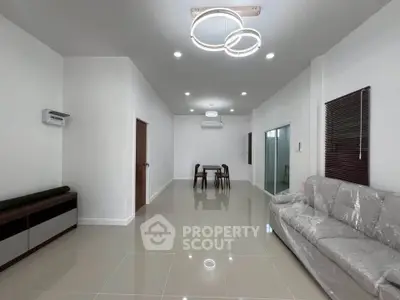 Spacious modern living room with sleek furniture and elegant lighting