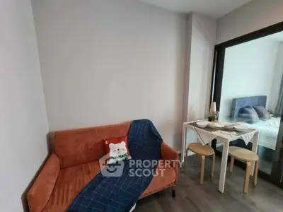 Cozy living area with modern decor and adjacent dining space