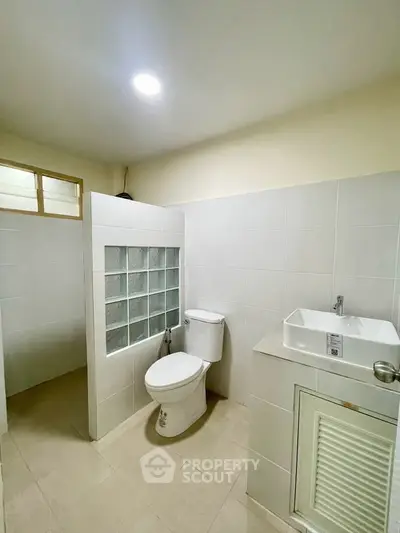 Modern bathroom with sleek fixtures and tiled walls in a contemporary home.