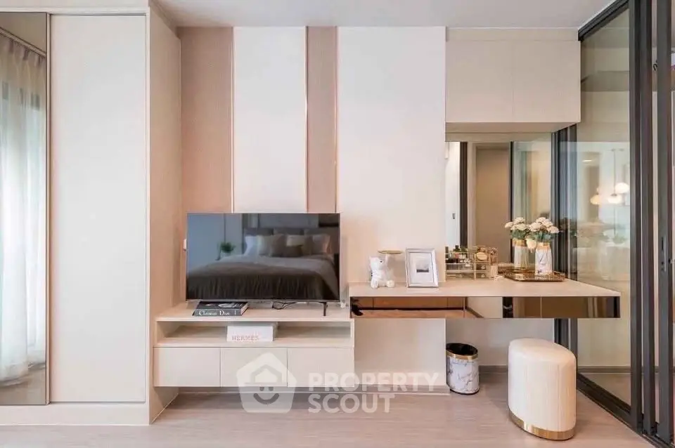 Modern living room with sleek TV unit and elegant decor in a stylish apartment.