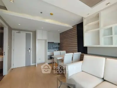Modern living room with sleek design and open kitchen layout in a stylish apartment.