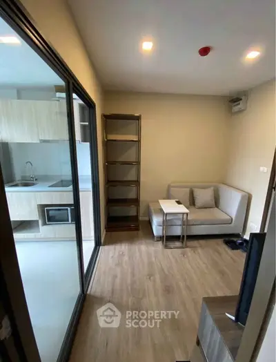Modern compact living room with open kitchen and cozy seating area