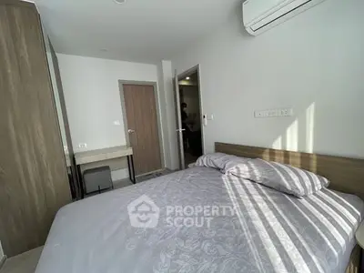 Cozy bedroom with modern furnishings and ample natural light