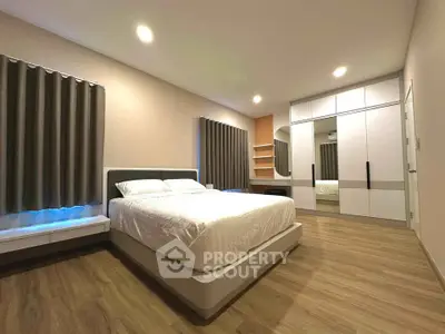 Spacious modern bedroom with elegant design and ample storage