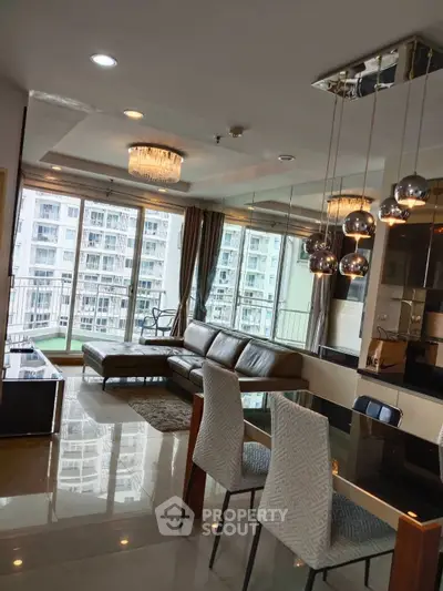 Luxurious living room with modern decor and stunning city view from large windows.