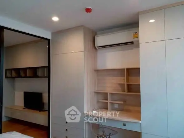 Modern study area with built-in desk and storage in a stylish apartment