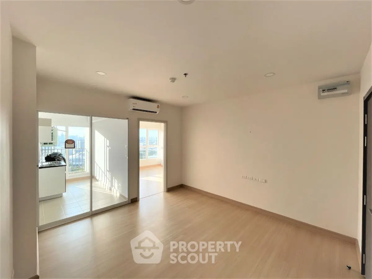Spacious modern living room with wooden flooring and balcony view