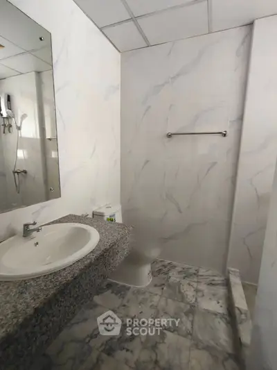 Modern bathroom with marble tiles and sleek fixtures