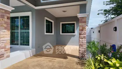 Charming home entrance with modern design and lush greenery